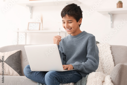 Happy little boy using lapt...