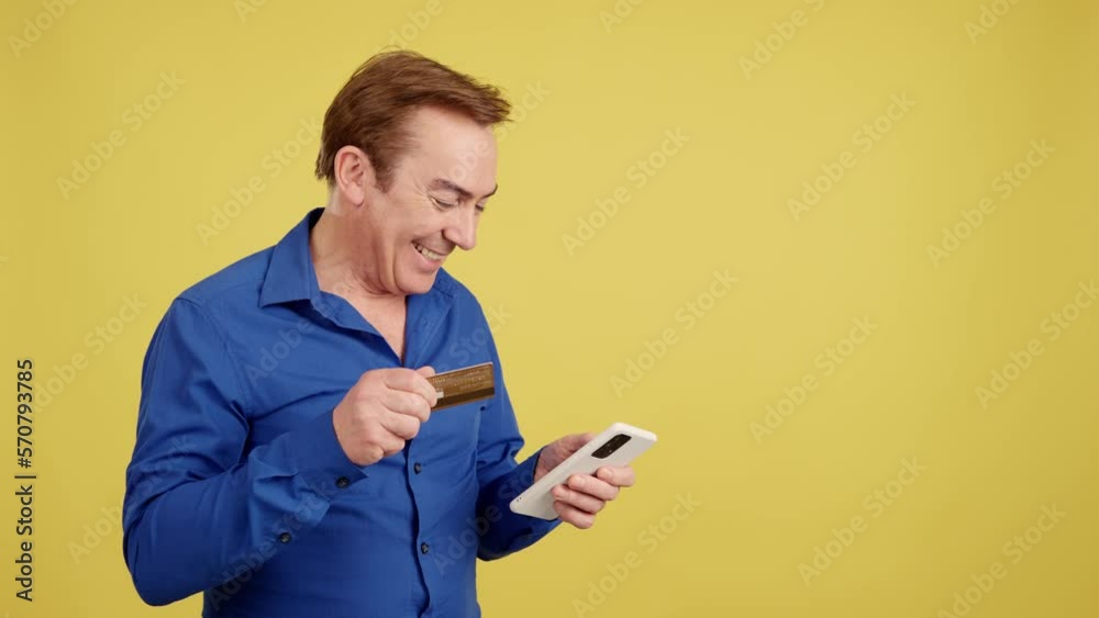 Mature man using the mobile and card to shopping online Mature man using the mobile and card to shopping online
