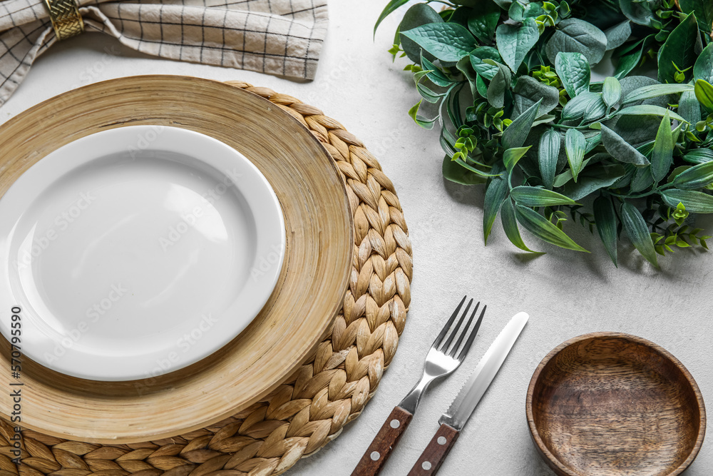Beautiful table setting with mistletoe wreath on white background Beautiful table setting with mistletoe wreath on white background