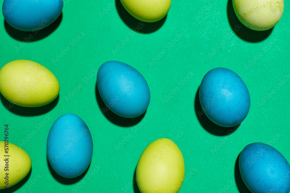 Composition with painted Easter eggs on green background Composition with painted Easter eggs on green background
