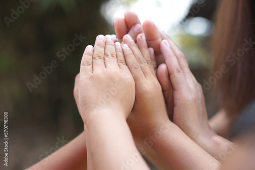 The hands of a child and a mother join forces.