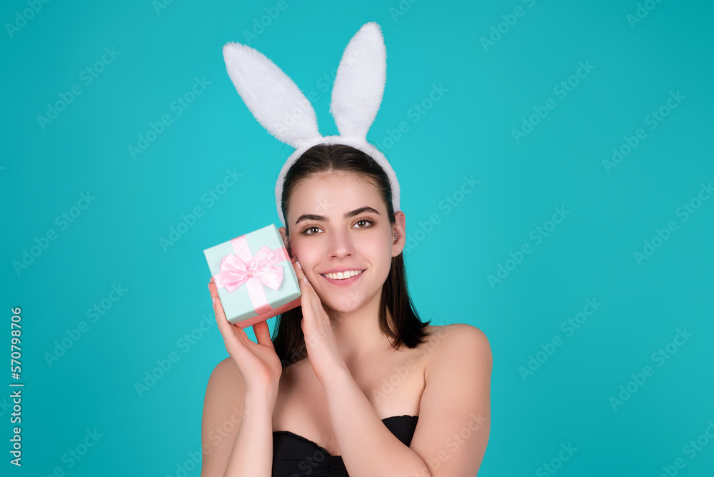 Beautiful young woman with bunny ears on studio color background. Easter funny woman with rabbit ears. Portrait of a pretty lovely girl with bunny ears.
