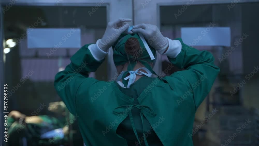 Portrait of a female surgeon getting ready wearing a mask in a hospital operating room. Portrait of a female surgeon getting ready wearing a mask in a hospital operating room.