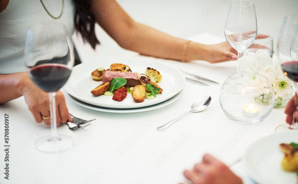 Couple, table and food at restaurant in closeup for valentines day date, bonding or romance in night. Man, woman and red wine glass with fine dining, service and hands for dinner, love or celebration Couple, table and food at restaurant in closeup for valentines day date, bonding or romance in night. Man, woman and red wine glass with fine dining, service and hands for dinner, love or celebration