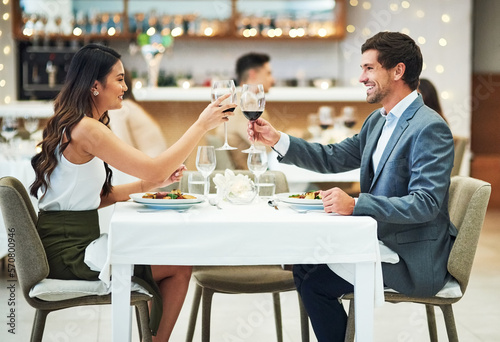 Love, wine and couple toast in restaurant for romantic dinner, honeymoon and anniversary celebration. Valentines day, fine dining and man and woman together for luxury date, alcohol drinks and relax