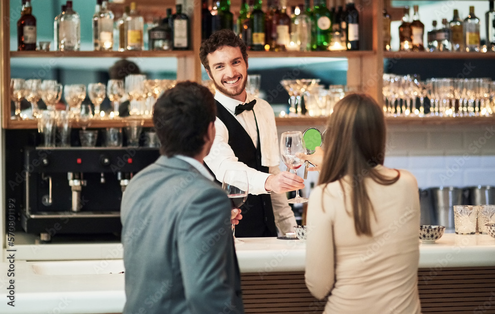 Bar, barman and serve a couple alcohol drinks on a date with hospitality, happy and smile at a hotel. Waiter, bartender and server help customers or people with good service for a celebration Bar, barman and serve a couple alcohol drinks on a date with hospitality, happy and smile at a hotel. Waiter, bartender and server help customers or people with good service for a celebration