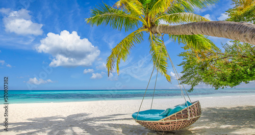 Romantic sunny beach. Palm tree with swing hanging before majestic clouds sky. Dream nature landscape, tropical island paradise, couple destination. Love coast, closeup sea sand. Relax pristine beach