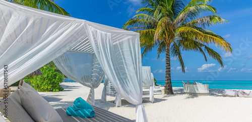 Fototapeta Naklejka Na Ścianę i Meble -  Relax on luxury VIP beach with white pavilions in sunny blue sky. Luxury vacation beach holiday in tropical resort, hotel. Couple retreat Fantastic leisure lifestyle landscape, palm trees white sand