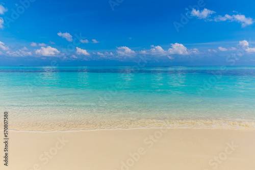 Closeup of sand on beach and blue summer sky. Panoramic beach landscape. Empty tropical beach and seascape. Orange and golden sunset sky, soft sand, calmness, tranquil relaxing sunlight, summer mood 