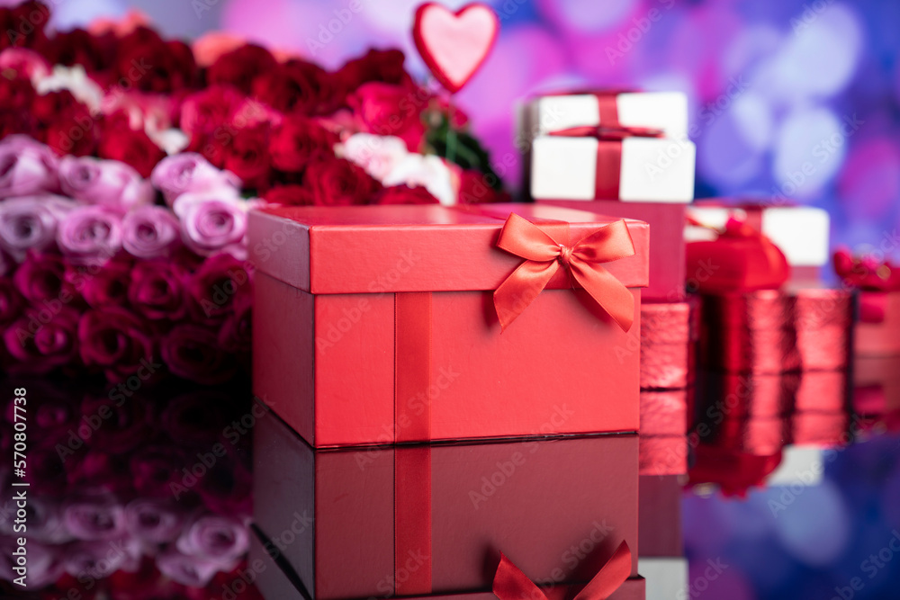 Obraz premium Valentines day theme. Gifts in boxes and big bouquet of natural roses on blue bokeh background.