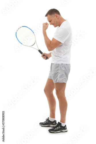 Winner, tennis sports and celebration of man in studio isolated on white background for exercise. Winning, achievement or mature male athlete with racket celebrating goals, targets or success victory © AW/peopleimages.com