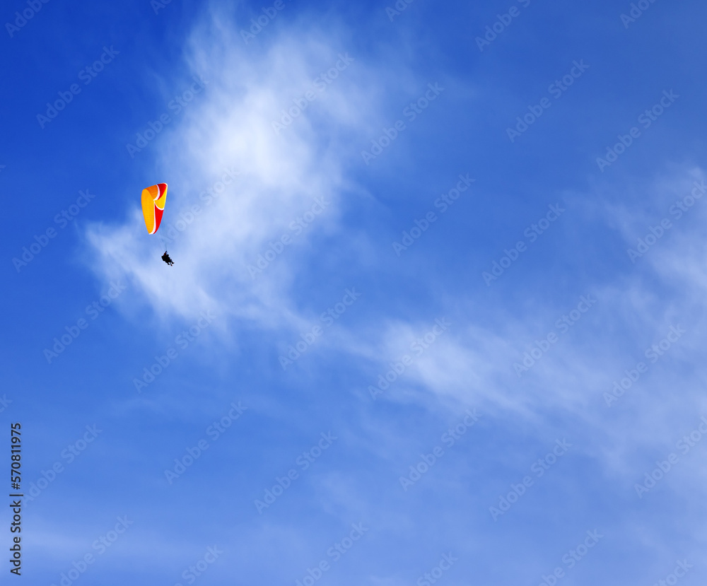 Skydivers in blue sky at sun day Skydivers in blue sky at sun day