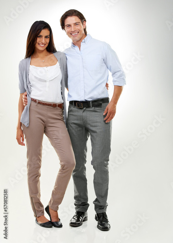 Couple, love and people standing together looking happy, confident and excited isolated in studio white background. Portrait, man and woman in a relationship in happiness feeling content