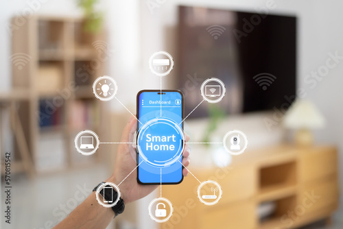 Hand man holding smartphone with smart home system control, Smart home concept