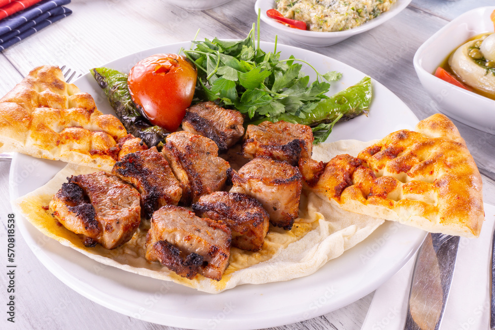 Asian style grilled beef skewers on a wood background, top view. Delicious appetizer, tapas, snack, turkish Asian style grilled beef skewers on a wood background, top view. Delicious appetizer, tapas, snack, turkish