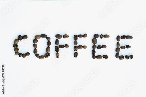 фотографія Coffee word made out of coffee beans on the white background with the insignific