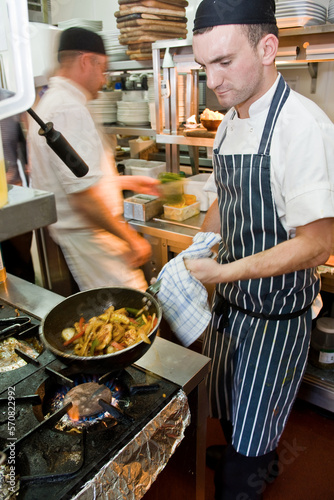 chefs working at commercial kitchen in the UK photo