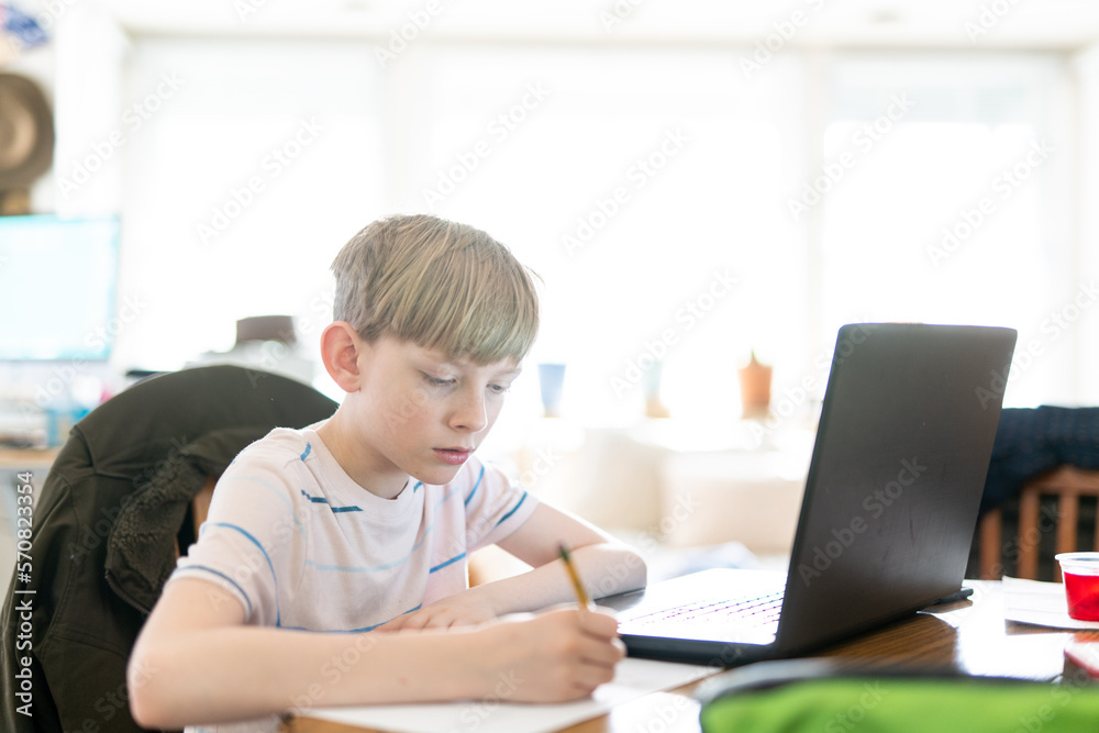 Tween working on homework remotely during shelter in place quarantine Tween working on homework remotely during shelter in place quarantine
