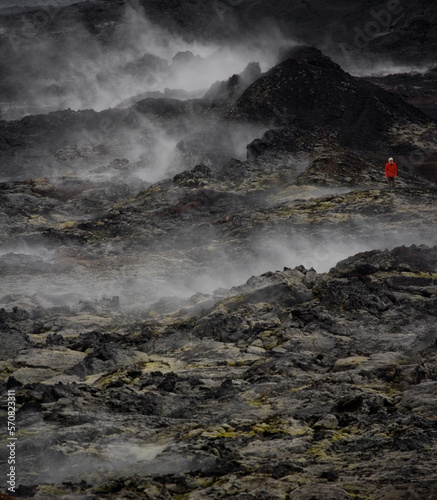 Woman hiking through the lava field at Krafla volcano photo