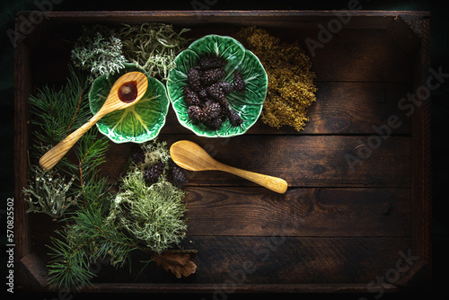 Cedar oil and pine cones on wooden background