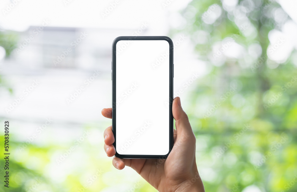 Hands holding smartphone with mockup of blank screen. Hands holding smartphone with mockup of blank screen.