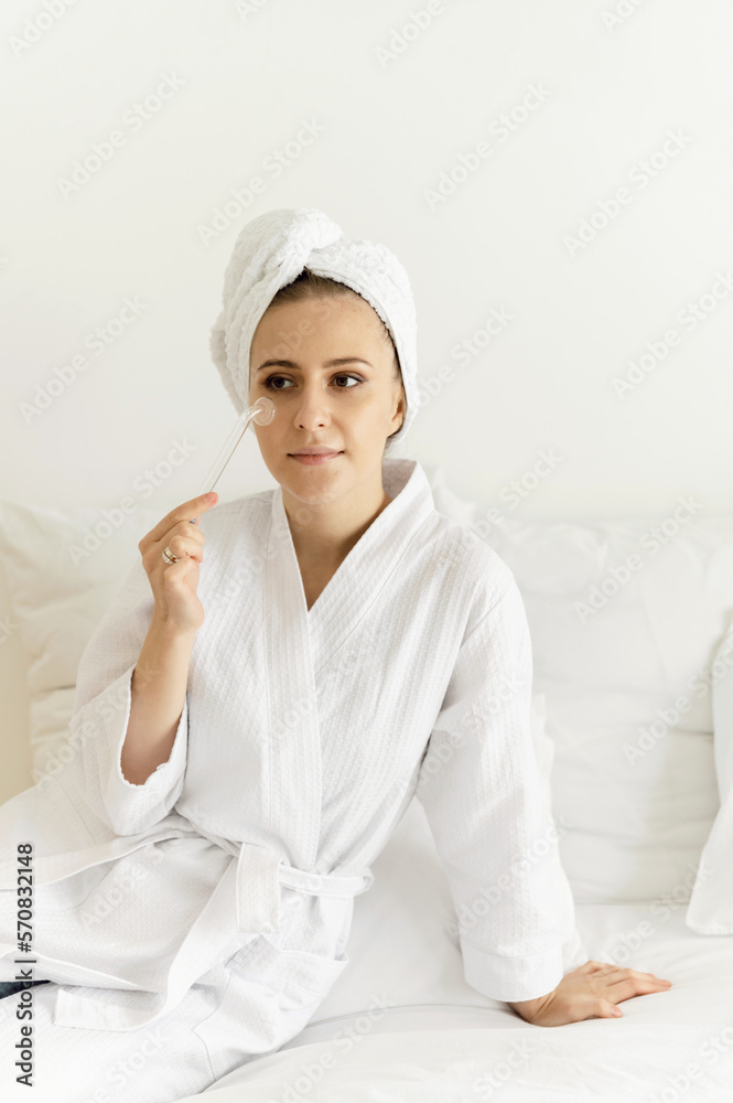 A beautiful girl uses darsonval for her face. facial care at home. facial cosmetology A beautiful girl uses darsonval for her face. facial care at home. facial cosmetology