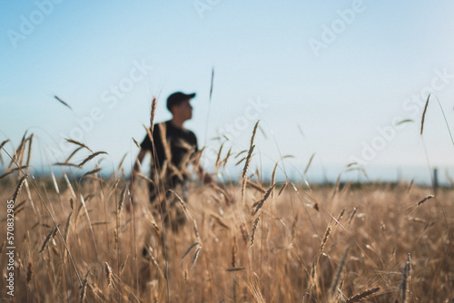 young man walking in the field blur