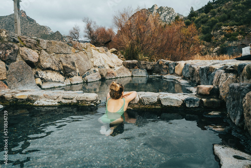 Portrait of woman in natural hot springs relaxing