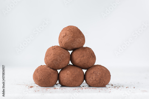 chocolate truffles covered in cocoa powder, homemade chocolate bonbons on white background photo