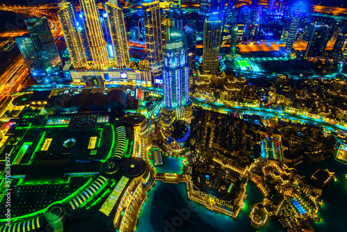 Aerial view of Downtown Dubai with dubai mall night view among skyscrapers and illuminated lights from a bird's eye view