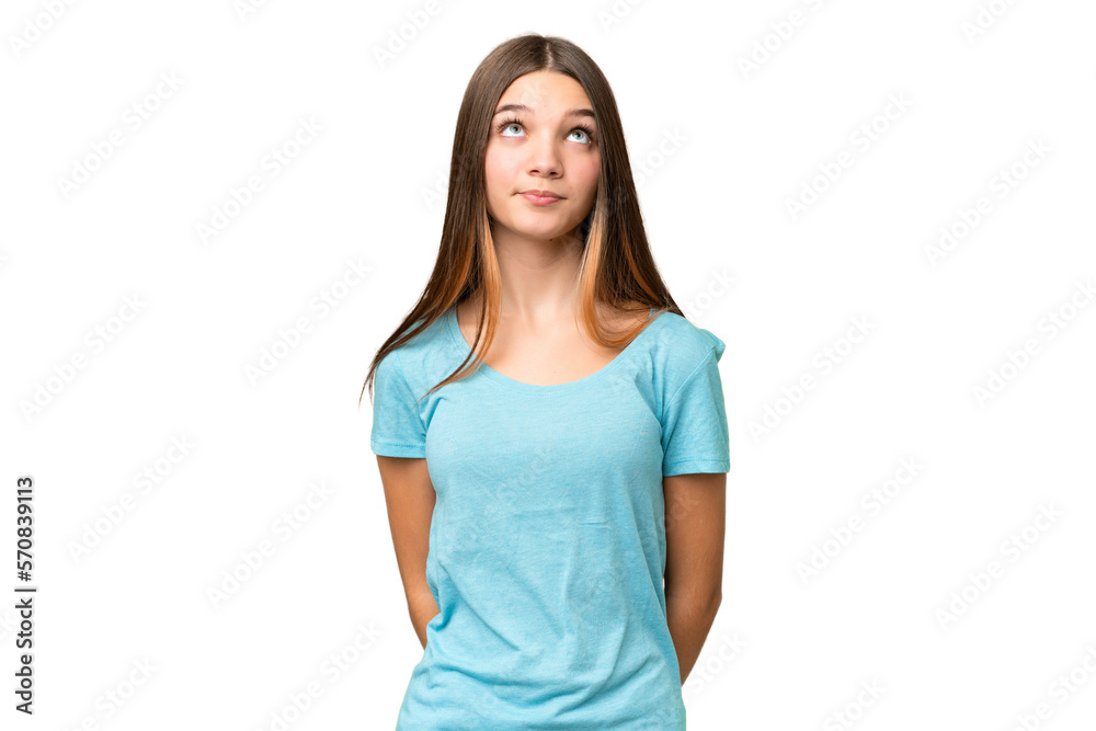 Teenager girl over isolated chroma key background and looking up Teenager girl over isolated chroma key background and looking up