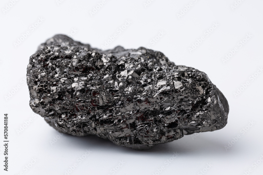 Fototapeta premium Natural black fossil coal on a white isolated background.