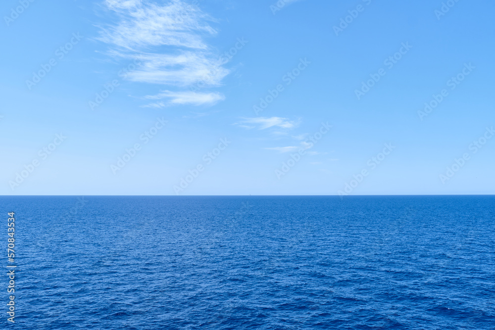 blue ocean with sun reflection, open sea with clear sky, calm sea with beautiful sunlight.