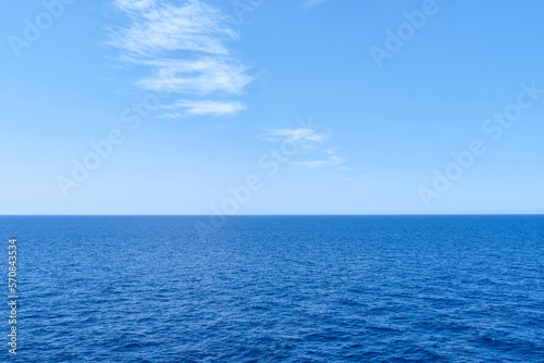 blue ocean with sun reflection, open sea with clear sky, calm sea with beautiful sunlight. © jordi