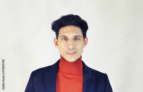 Handsome young man on white backgroundo, looking at camera with smile photo
