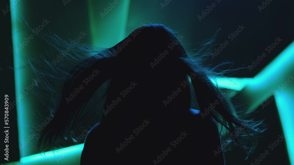 Close up portrait of pretty brunette female model . Beautiful attractive face of young woman . Hair flowing or blowing in wind . Face Changes Depending on the Lighting . Shadow and light movement . 