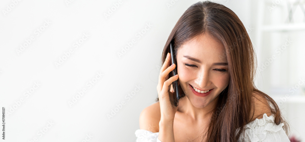Portrait of smiling happy beauty asian business woman relaxing using digital technology smartphone.Young asian girl work call and talk with friend business team at home. Portrait of smiling happy beauty asian business woman relaxing using digital technology smartphone.Young asian girl work call and talk with friend business team at home.