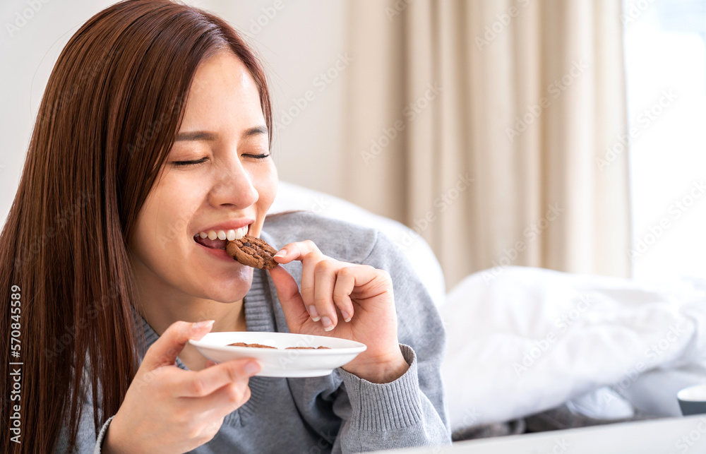 Portrait of smiling cheerful beautiful pretty asian woman clean fresh healthy white skin posing smile in pajamas clothes.Girl felling relax and enjoy time on the bed at home.asia beauty Portrait of smiling cheerful beautiful pretty asian woman clean fresh healthy white skin posing smile in pajamas clothes.Girl felling relax and enjoy time on the bed at home.asia beauty