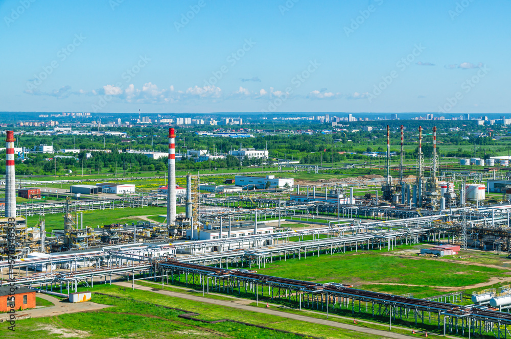 Flare installations of an oil refinery for the removal of flammable gases and vapors into the atmosphere. Pipes for the removal of chemical emissions into the atmosphere. Petrochemical plant.