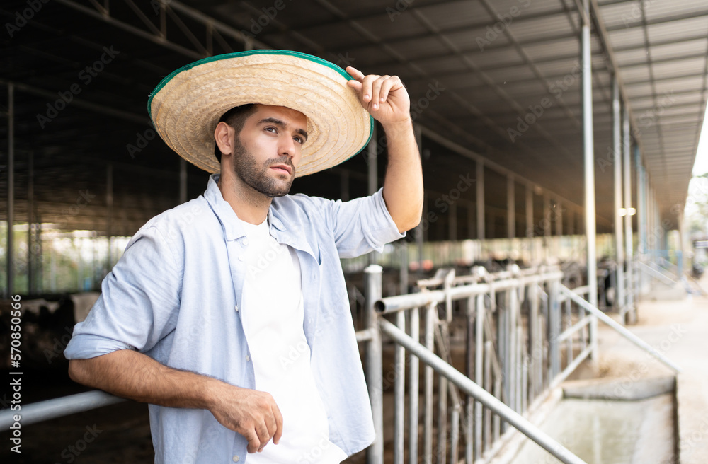 Portrait of a Hispanic Middle eastern Man farmers who are standing at the cow farm.