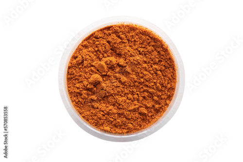 Curry powder in round white bowl isolated on white background. Top view.