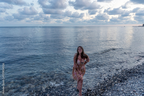 young woman at sunset by the sea