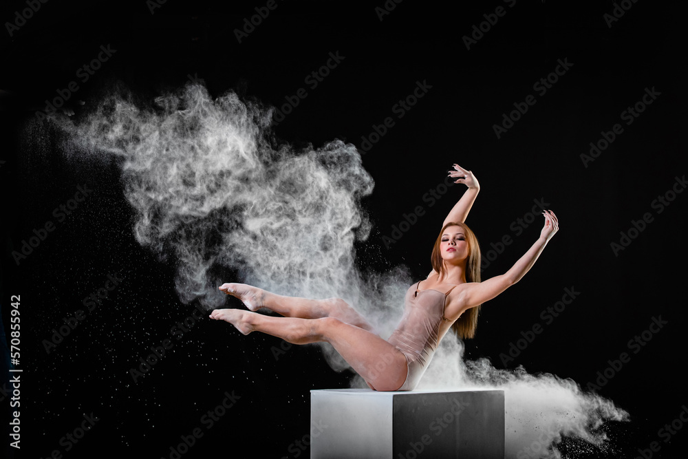 Young slim woman with spread flour on the air