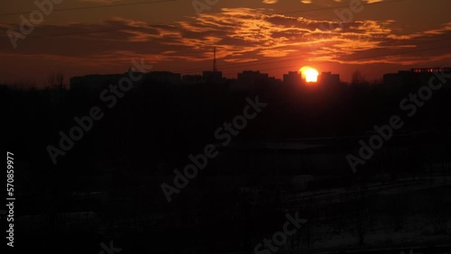 Sunset in the city in industrial area car riding in the darkness