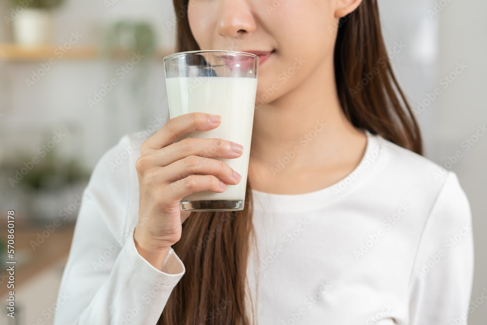 Health care, pretty asian young woman, girl drinking a glass of white fresh, dairy milk for calcium, vitamin wholesome good nutrition in morning at kitchen home. lifestyle, product healthy people. Health care, pretty asian young woman, girl drinking a glass of white fresh, dairy milk for calcium, vitamin wholesome good nutrition in morning at kitchen home. lifestyle, product healthy people.