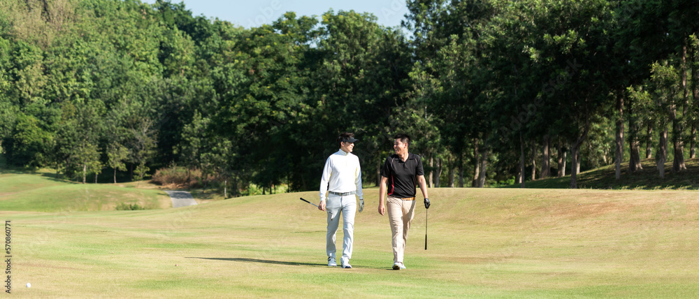 Group golf professional Golfer asian man walking in fairway with bag golf at golf club. Hobby in holiday and vacation with friends. Lifestyle and Sport Concept Group golf professional Golfer asian man walking in fairway with bag golf at golf club. Hobby in holiday and vacation with friends. Lifestyle and Sport Concept
