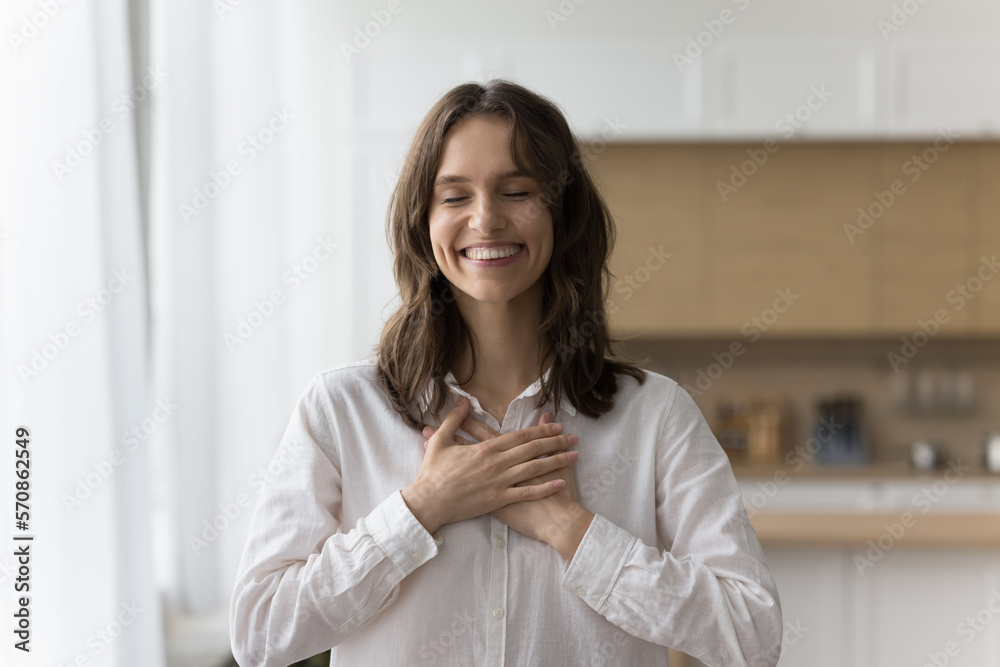 Happy peaceful pretty woman making gesture of gratitude, thank, pride, kindness, stacking hands on chest with toothy smile and closed eyes, enjoying peace, positive, thankful emotions Happy peaceful pretty woman making gesture of gratitude, thank, pride, kindness, stacking hands on chest with toothy smile and closed eyes, enjoying peace, positive, thankful emotions