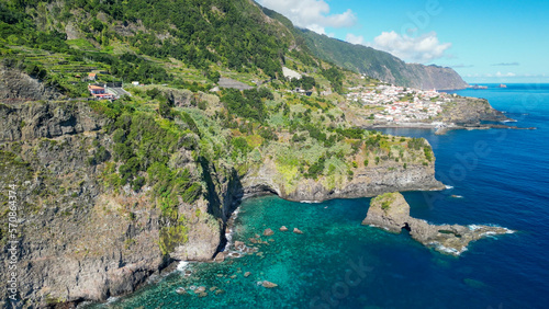 Beautiful wild coast scenery view with Bridal Veil Falls  Veu da noiva  at Ponta do Poiso in Madeira Island. Aerial view