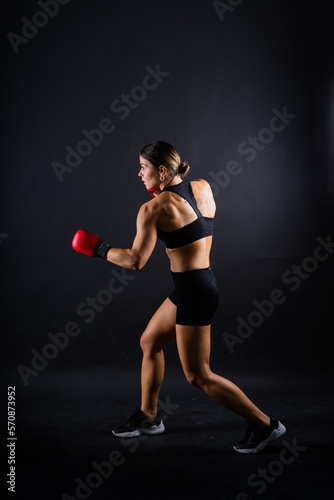 Woman do high kick, tae-bo. Athletic fit female with perfect body kick air, punching with legs © Ivan Zelenin