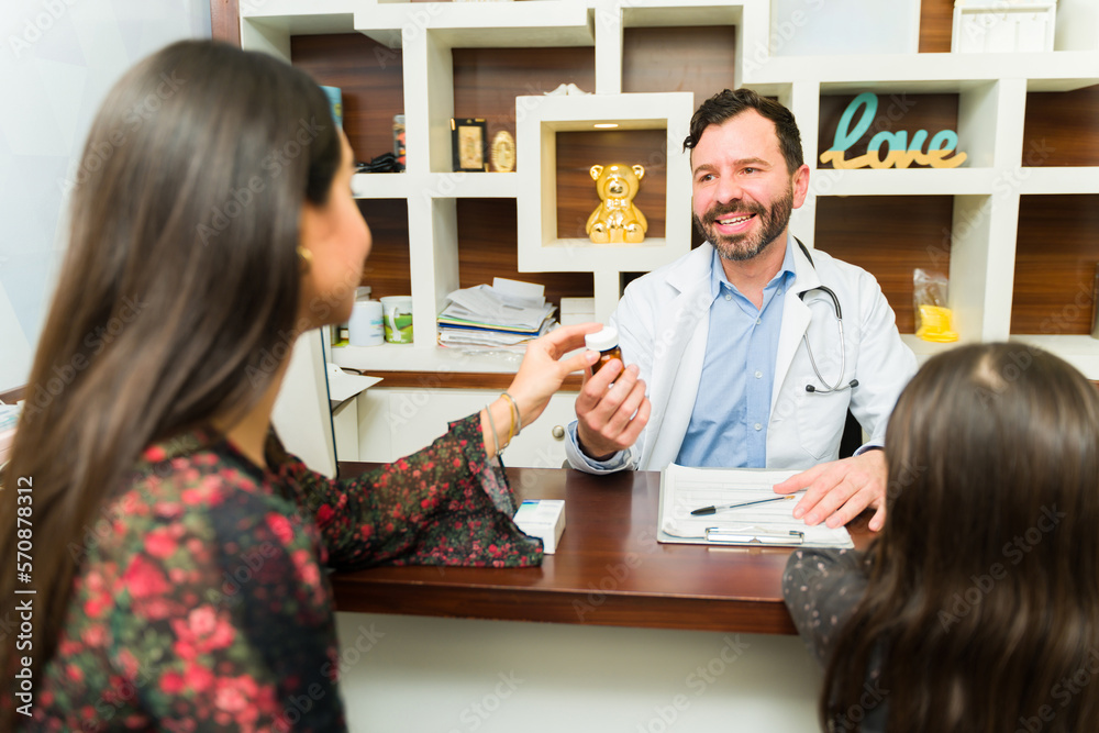 Happy pediatrician doctor with a family Happy pediatrician doctor with a family
